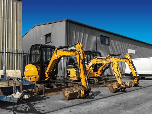 diggers in front of warehouse