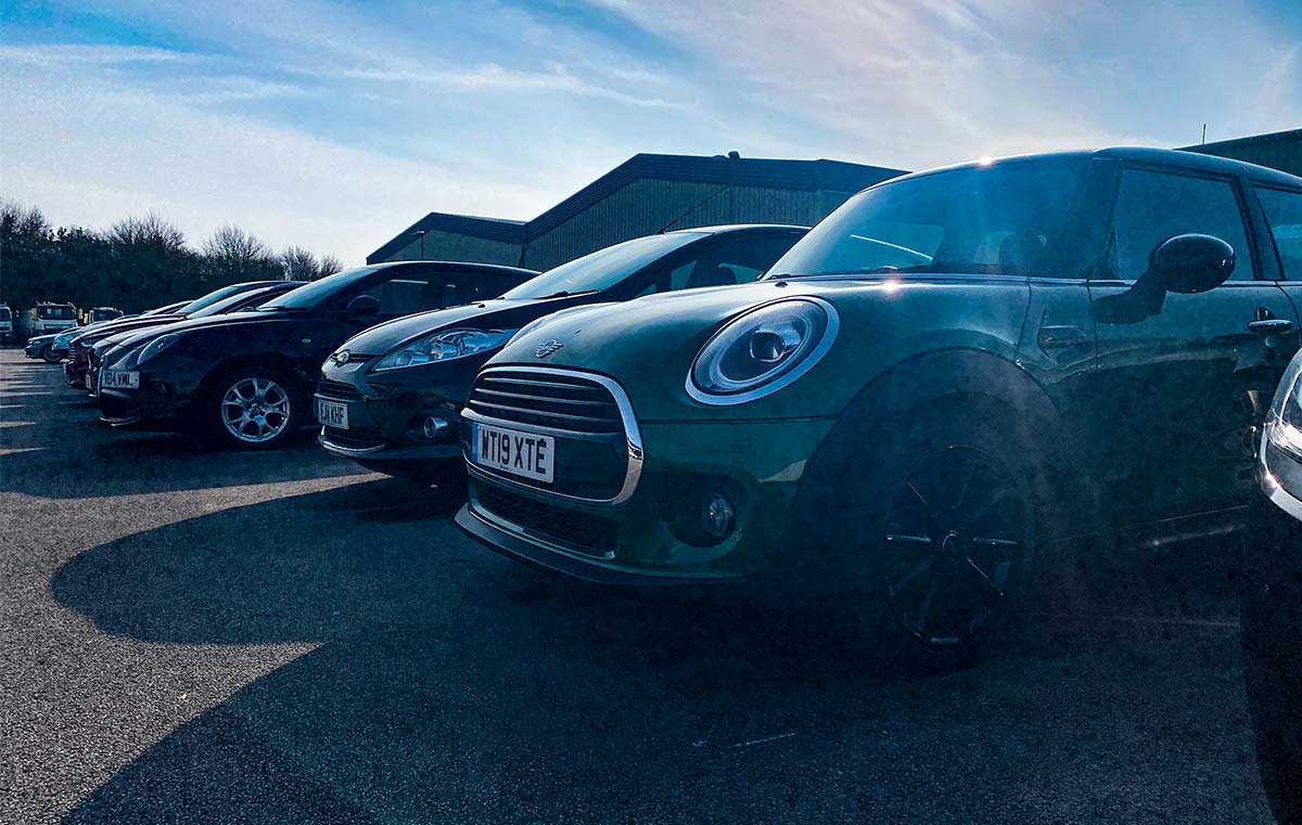 cars in front lot under sunshine